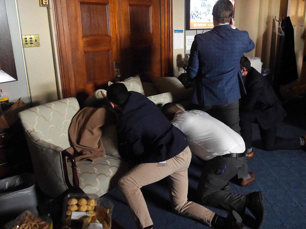 Congress staffers barricade themselves after Trump supporters stormed inside the US Capitol in Washington, DC. Picture: Olivier Douliery / AFP)