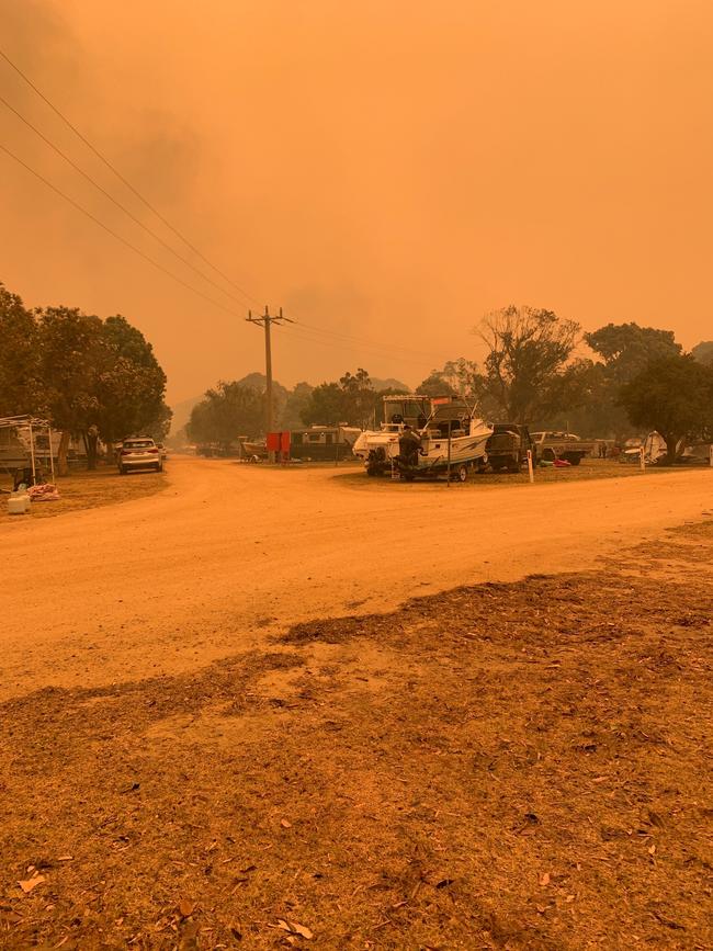 A caravan park on the Mallacoota foreshore is blanketed in orange. Picture: Supplied