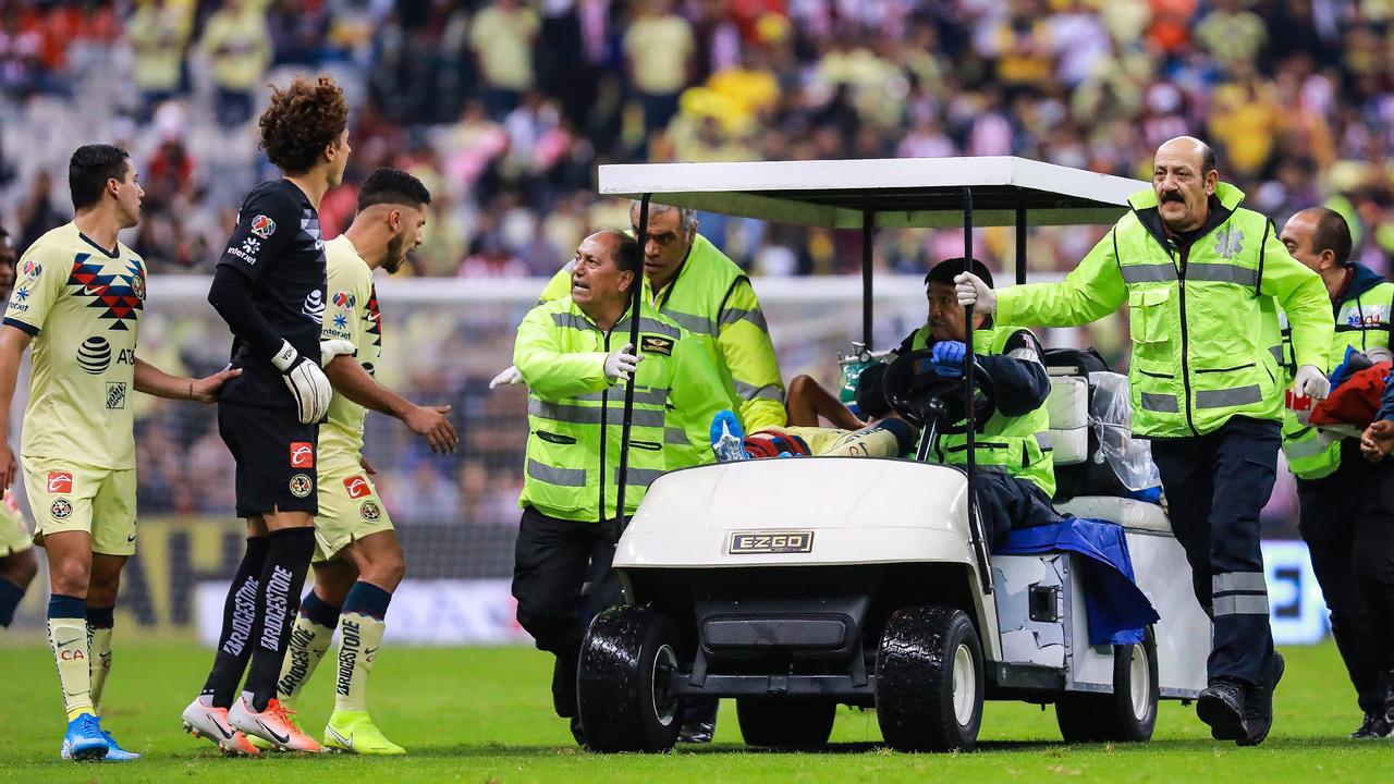 Players crowded the cart as Giovani Dos Santos was taken from the field after the incident