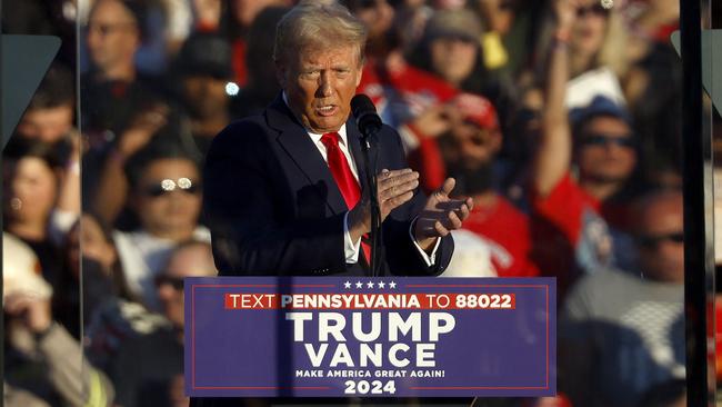 Mr Trump addresses a campaign rally from behind bullet resistant glass. Picture: Kevin Dietsch/Getty Images/AFP