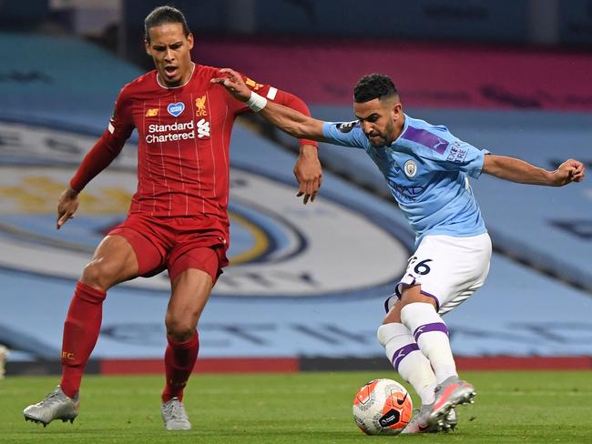 Manchester City's Algerian midfielder Riyad Mahrez (R) shoots to score the fifth goal but it is disallowed by VAR (Video Assistant Referee) during the English Premier League football match between Manchester City and Liverpool at the Etihad Stadium in Manchester, north west England, on July 2, 2020. - Manchester City won the game 4-0. (Photo by LAURENCE GRIFFITHS / POOL / AFP) / RESTRICTED TO EDITORIAL USE. No use with unauthorized audio, video, data, fixture lists, club/league logos or 'live' services. Online in-match use limited to 120 images. An additional 40 images may be used in extra time. No video emulation. Social media in-match use limited to 120 images. An additional 40 images may be used in extra time. No use in betting publications, games or single club/league/player publications. /