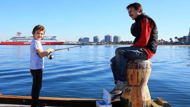 Mike Burston fishing with son Will at Port Melbourne after COVID-19 restrictions were eased. Picture: Aaron Francis