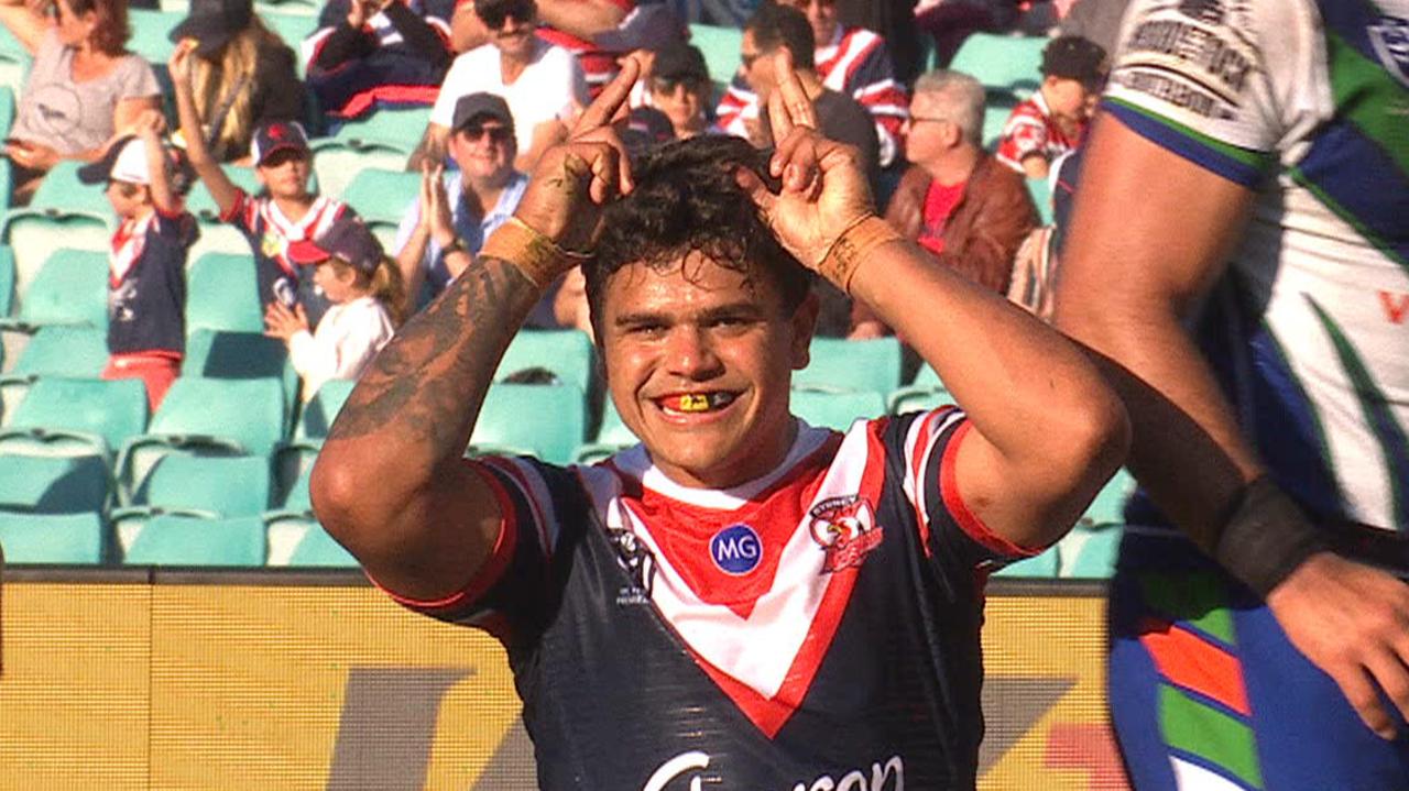 Latrell Mitchell celebrates after scoring a try for the Roosters.