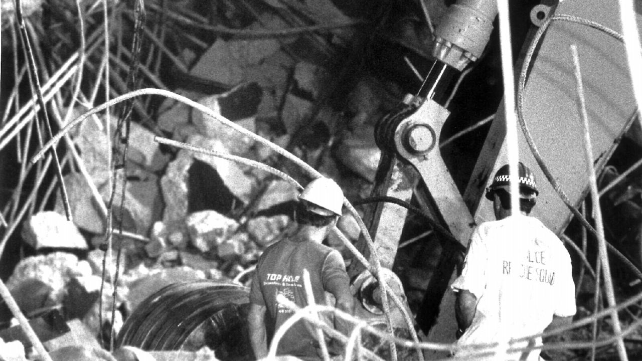 Police &amp; demolition workers guide an excavator digging around where two bodies are buried in the wreckage of the Newcastle workers club. Picture: Supplied