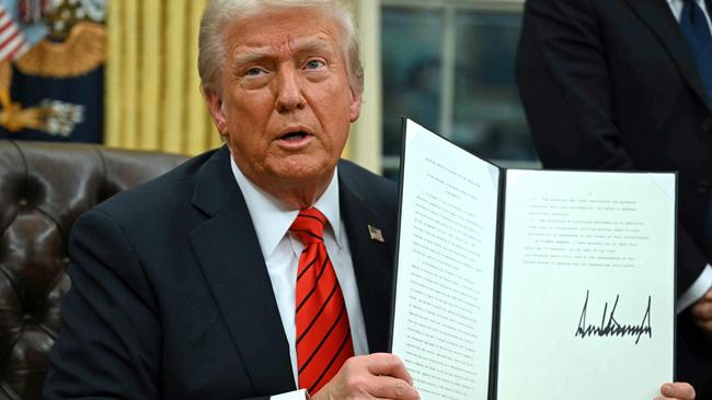 Donald Trump signs the executive order on tariffs. Picture: AFP.