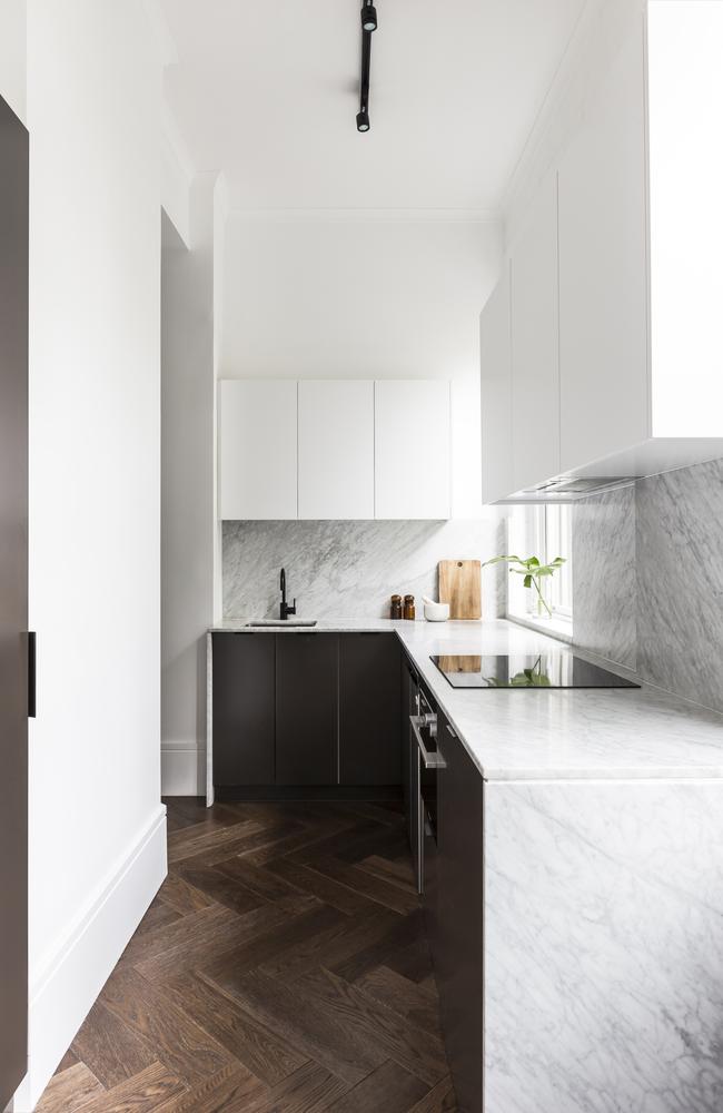 The herringbone floors provide a textural backdrop in the kitchen.