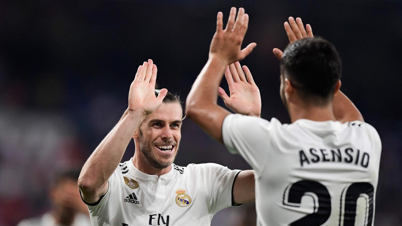 Gareth Bale celebrates with Marco Asensio.