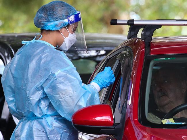 SYDNEY, AUSTRALIA - NewsWire Photos, DECEMBER 20 2021: People are seen lining up to get a Covid-19 test at the Burwood Covid Testing clinic in Sydney ahead of Christmas as positive cases continue to rise in NSW. Picture: NCA Newswire / Gaye Gerard