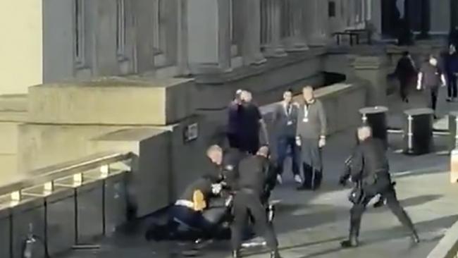 A man is surrounded by armed police after a terrorist attack on London Bridge.