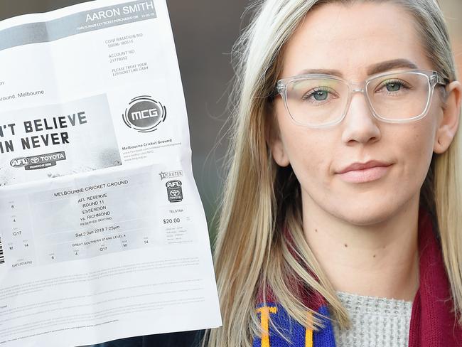 Amy McCarthy who bought a ticket online for the Richmond-Essendon match  and turned up to the game only to fund the ticket was fake. Amy at Colllingwood with a copy of the fake ticket. Picture: Lawrence Pinder