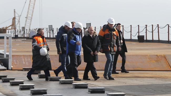 Russian President Vladimir Putin inspects the road section of the road-and-rail Crimean Bridge over the Kerch Strait in 2018. Picture: AFP