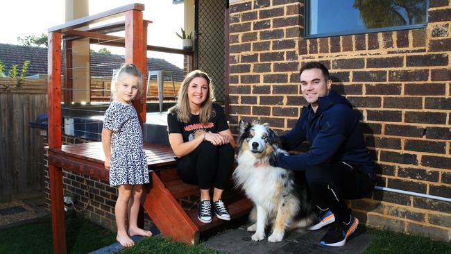 Jade Lawton and James Brick with daughter Indiana, 5, and dog Ralph at their home in Chadstone. Picture: Aaron Francis