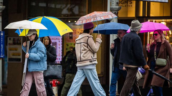 People on the streets of Adelaide shelter from the rain. Picture: File