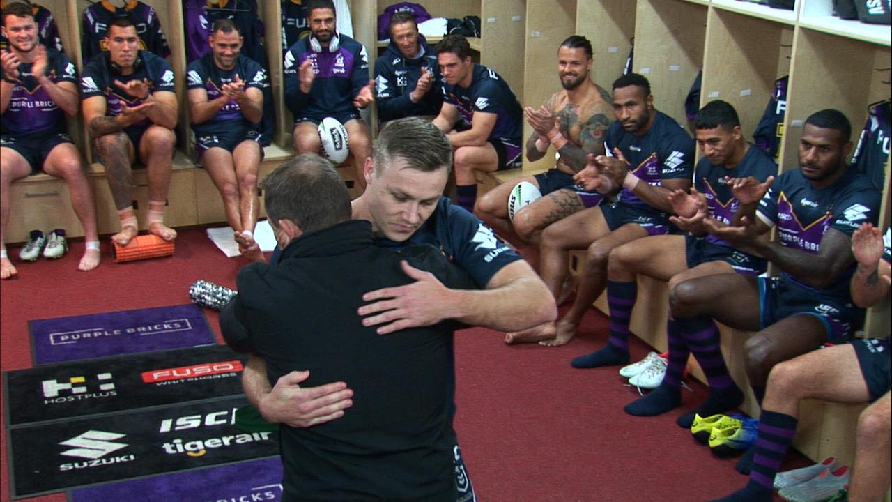 Billy Walters is presented with his debut NRL jersey from his father Kevin Walters.