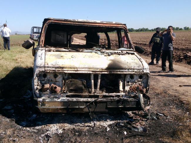 Tragic find ... Mexican authorities inspect a burnt out van suspected to belong to the Australian tourists missing for more than a week, in Sinaloa, Mexico. Picture: AP