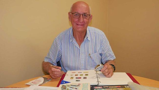 STAMPED: Peter Rule tending to his impressive stamp collection. Picture: Eden Boyd