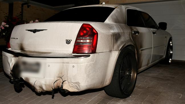 The Chrysler sedan belonging to a former Comanchero was damaged when at least two bombs were placed underneath it on Avery St, Rutherford on October 27, 2022. Picture: NSW Police.