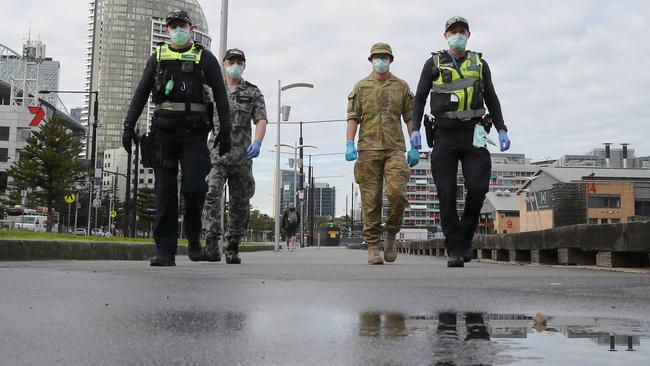 Police and ADF patrol Docklands during stage four lockdown. Picture: David Crosling