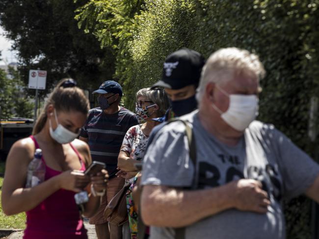 People wear face masks as they wait to receive a COVID-19 test outside the Sunbury Respiratory Clinic in Melbourne. Picture: Getty Images