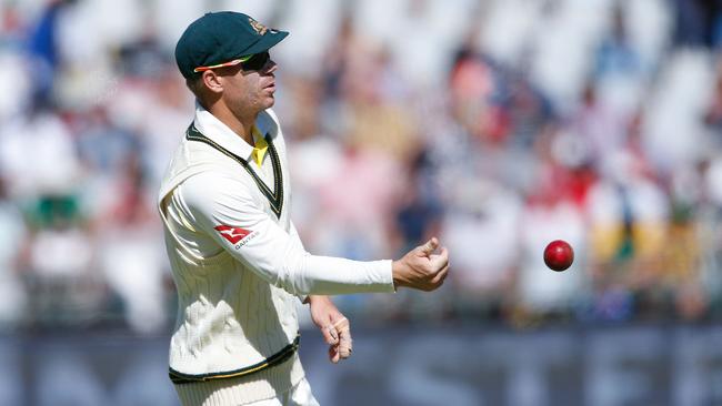 David Warner passes the ball during the fourth day of the third Test cricket match on Sunday. Picture: AFP/Gianluigi Guercia