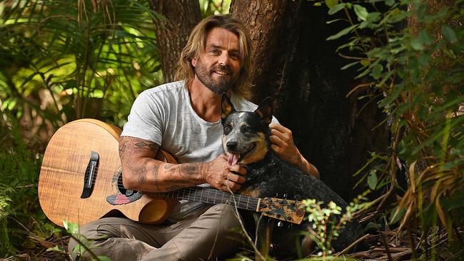 Singer-songwriter Xavier Rudd with his cattle dog Indi on his property in Doonan, outside Noosa on the Sunshine Coast. Picture: Lyndon Mechielsen