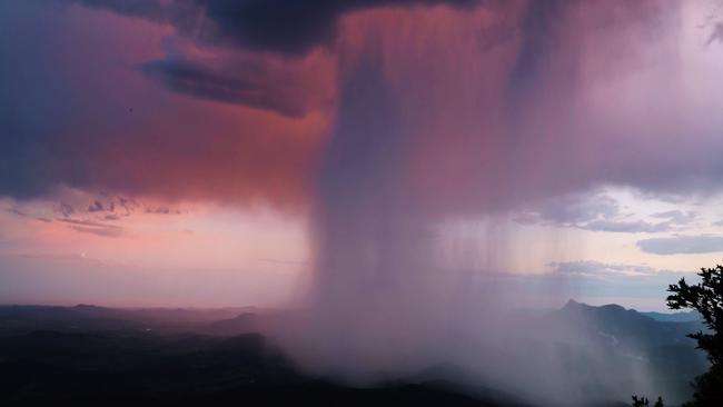 The view from the 'best of all lookout' as a curtain of rain was passing and the sun was setting. Picture: Samantha Schull