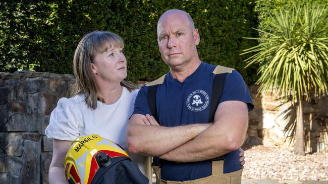 Firefighter Gary Marsh with his wife Shani in their backyard. Mr Marsh lives with an incurable cancer, but a loophole in the Return to Work Act means he risks being cut off from his wages. Picture: Mark Brake