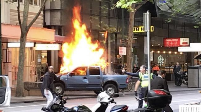 The vehicle on fire in Bourke Street. Picture: @chrismacheras/Twitter