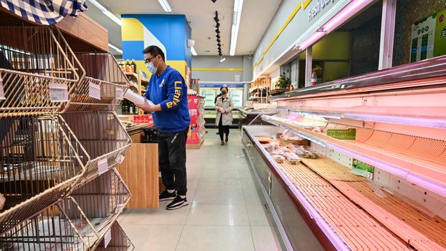 Shoppers rummage through empty shelves in a supermarket during Shanghai’s lockdown. Picture: Hector Retamal/AFP