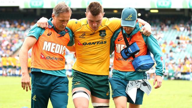 Wallaby Jack Dempsey is helped from field after being injured against the Barbarians in Sydney in October last year. Picture: Getty Images