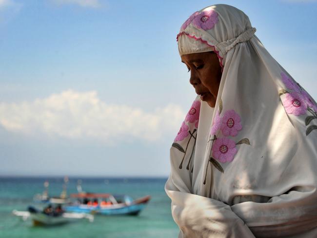 Praying at a beach near the town of Sekaroh on the island of Lombok in Indonesia's West Nusa Tenggara province. AFP PHOTO / SONNY TUMBELAKA