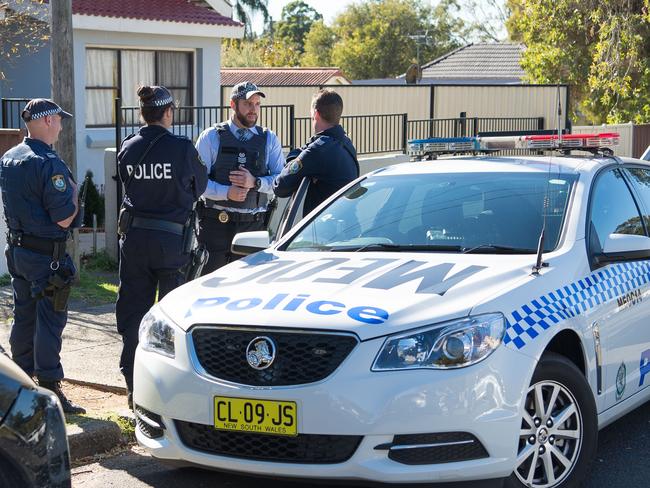 Officers at Punchbowl following one of the raids. Picture: AAP