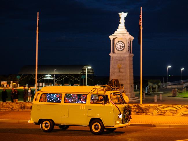 A van, playing the bugle drives along the foreshore at Semaphore at dawn. Image Morgan Sette.