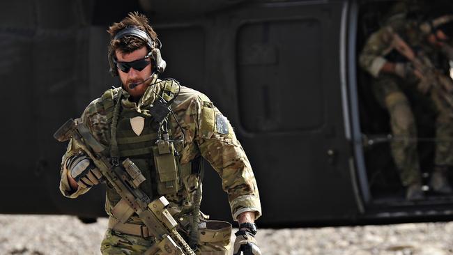 SAS Corporal Ben Roberts-Smith VC, MG, with the Australian Special Operations Task Group, leaves a UH-60 Blackhawk helicopter during preparation of the Shah Wali Kot offensive in Afghanistan, 06/2010. Roberts-Smith was later awarded the Victoria Cross during action in saving the lives of wounded comrades.