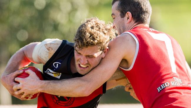 Nepean footy: Frankston v Red Hill at Greg Beck Oval. Michael Dillon of Red Hill tackles Frankston's James Degenhardt. Picture Stuart Walmsley