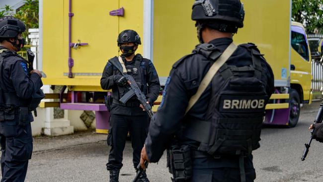 Indonesian police guard a truck carrying Sinovac vaccines in Banda Aceh last week. Picture: AFP