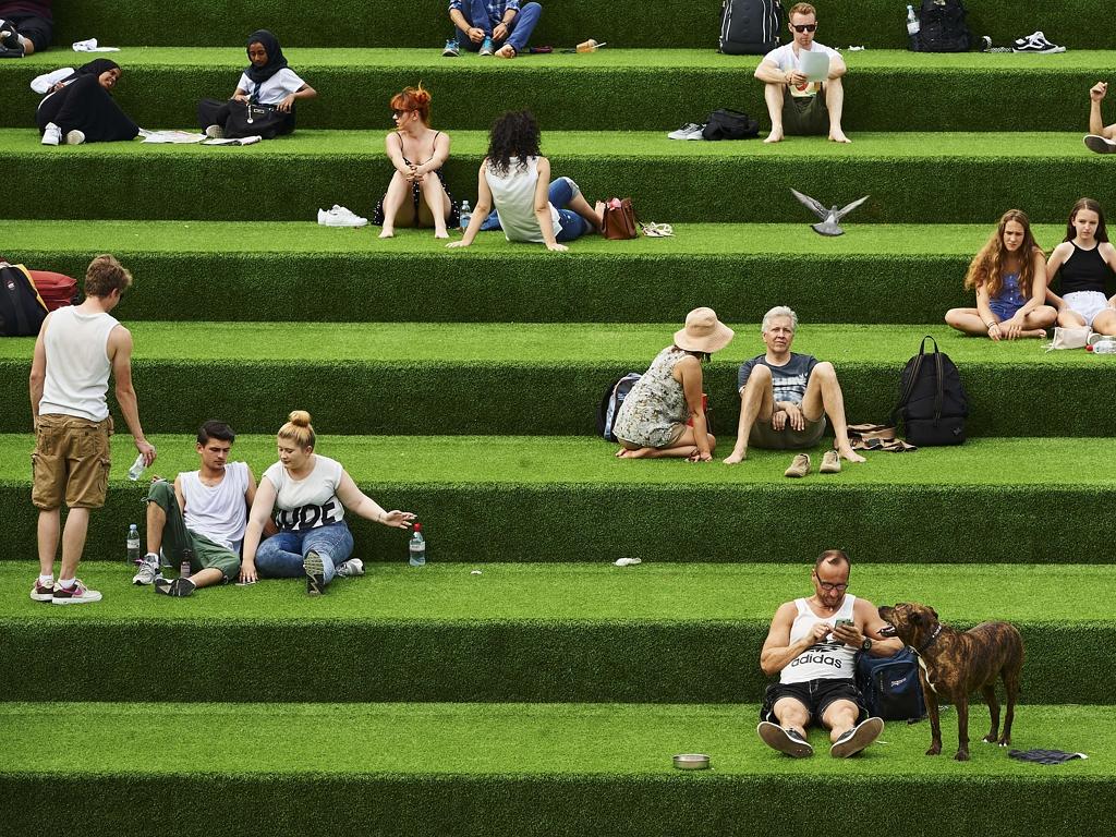 Members of the public enjoy the warm weather in central London on July 1, 2015. Picture: AFP