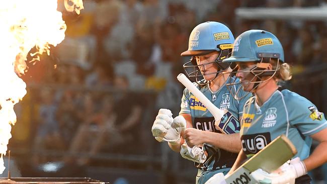 Grace Harris and Beth Mooney of the Heat walk out to bat during the Women's Big Bash League match between the Brisbane Heat and the Sydney Thunder at Cazalys Stadium on January 12, 2019 in Cairns. (Photo by Ian Hitchcock/Getty Images)