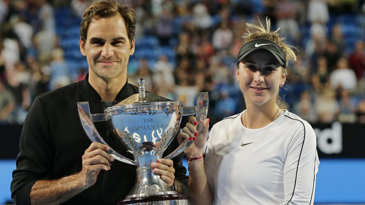 Roger Federer and Belinda Bencic of Switzerland celebrate with the Hopman Cup after their win in Perth on Saturday night. Picture: Getty Images 