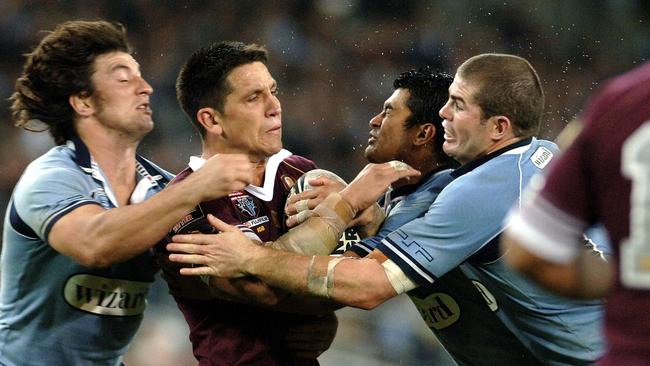 Maroons player Steve Price gets hit by Nathan Hindmarsh (left), Craig Wing and Andrew Ryan (right) in the 2006 Origin series. Picture: Craig Wilson)