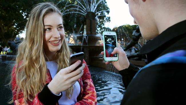 Tamra Foy and Finn Melville playing Pokemon Go at Hyde Park. Picture: Richard Dobson