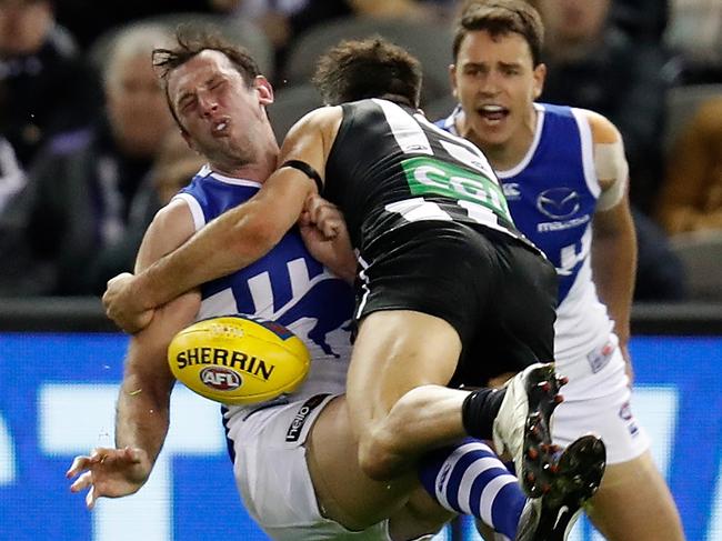 Kangaroos Todd Goldstein (left) is tackled by Levi Greenwood of the Magpies during their match at Marvel Stadium. Picture: Michael Willson/AFL Photos via Getty Images