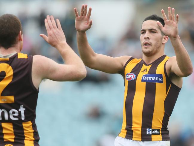 Shane Savage of Hawthorn is congratulated by teammate Jarryd Roughhead.