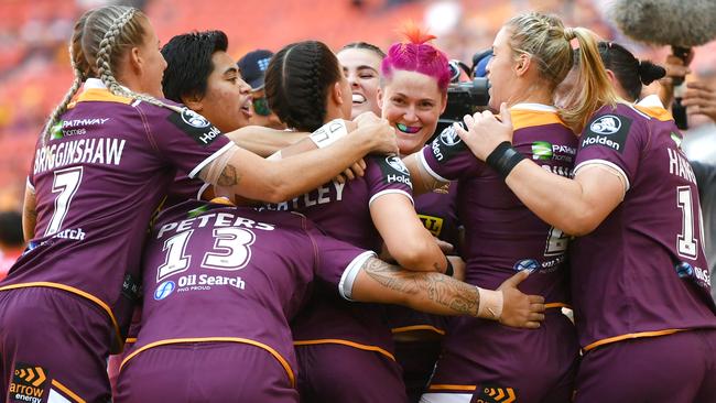 Chelsea Baker (centre) of the Broncos celebrates scoring a try with team mates during the Chelsea Baker (centre) celebrates scoring a try with her Broncos teammates during the NRL Women's clash against theDragons at Suncorp Stadium. Picture: AAP