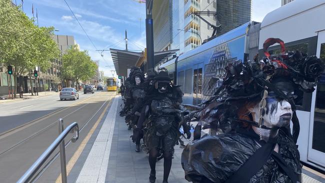 Extinction Rebellion protesters on the tram on the way to the Adelaide Convention Centre. Picture: Todd Lewis