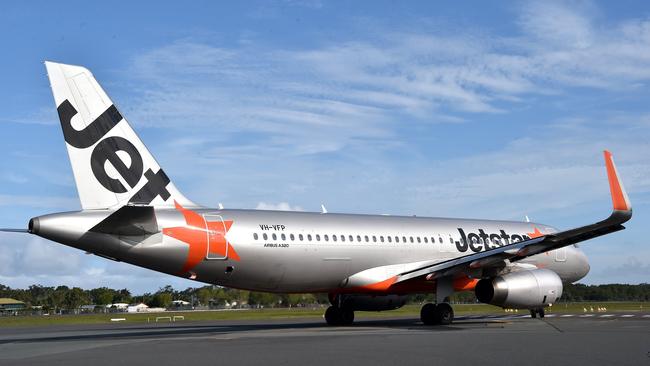 Sunshine Coast Airport CEO Peter Pallot is pictured with a Jetstar plane in the background.