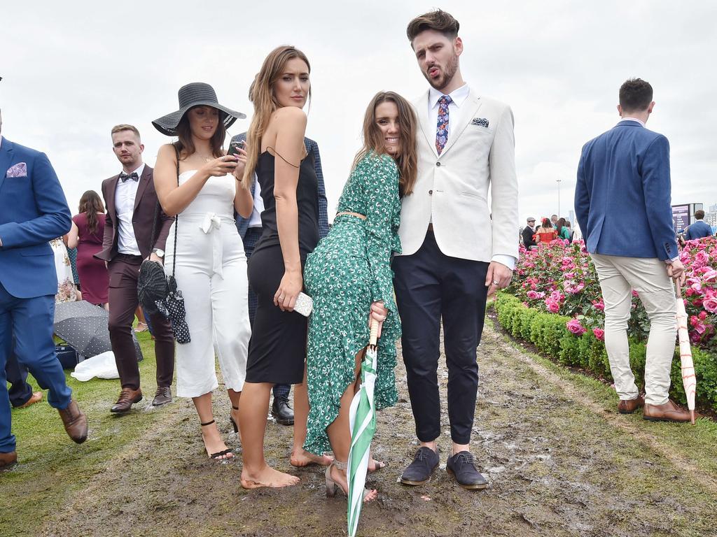 Punters in the mud at the 2018 Melbourne Cup Flemington. Picture: Jason Edwards