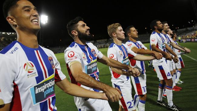 Newcastle Jets players thank their travelling fans.