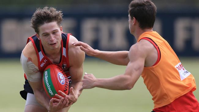 Jack Billings breaks a tackle from Jack Sinclair at St Kilda training.