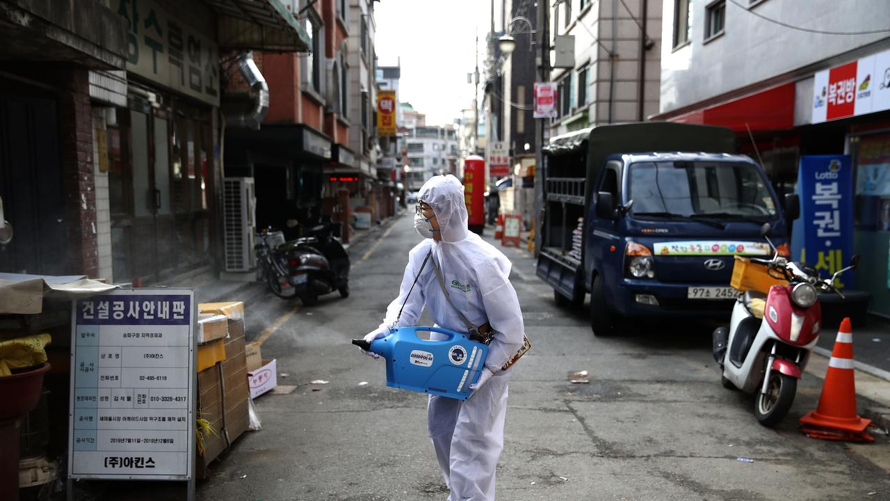 Workers spray disinfectant at a market in Seoul, South Korea. Picture: Chung Sung-jun/Getty Images